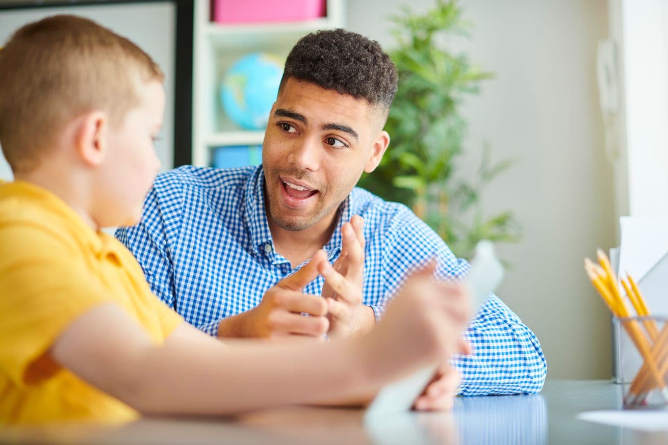 A little boy is learning to count with the help of his educational therapist. Gaining confidence in math is a key benefit of educational therapy.